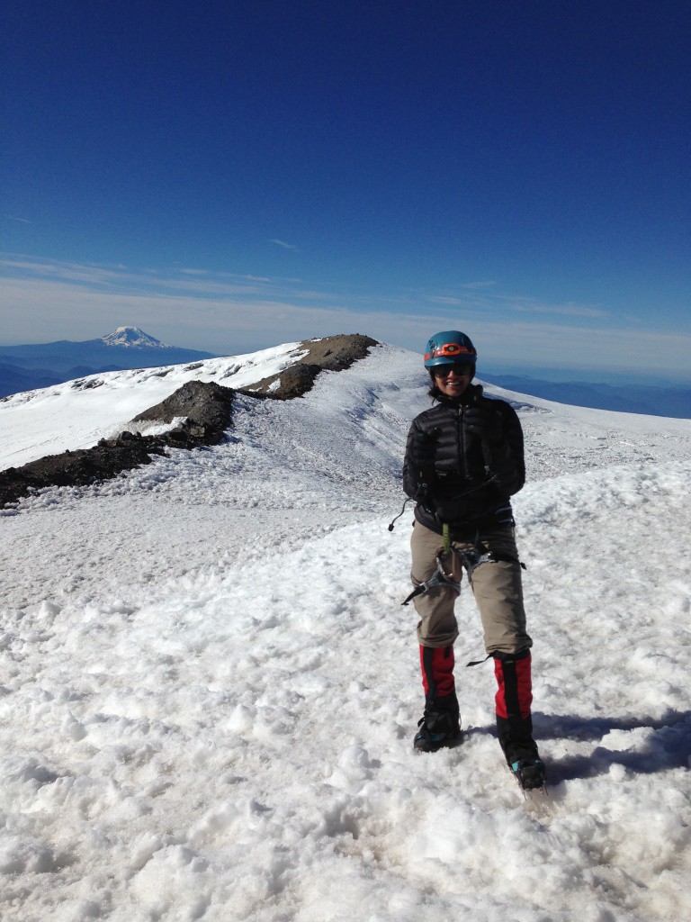 On the summit of Mt. Rainier with Mt. Adams seen far away in the background