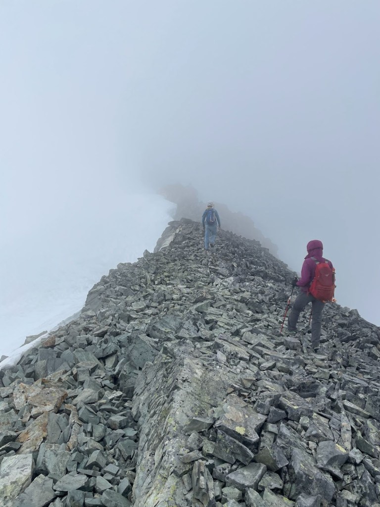 Scrambling along the exposed ridge of the Armchair Traverse between Mount Cook and Mount Weart