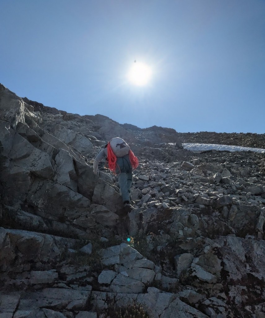 Scrambling up loose scree towards the base of DOA Buttress on Blackcomb Peak